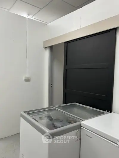 Spacious storage room with modern freezers, ideal for extra home storage needs.