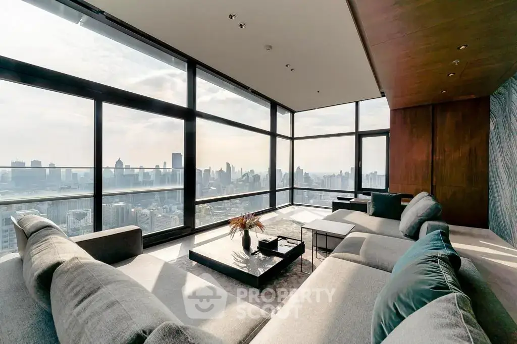 Luxurious living room with panoramic city views and modern furnishings in a high-rise apartment.