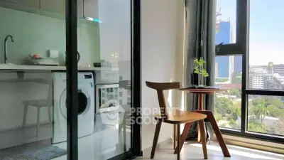 Modern apartment with washing machine and city view, featuring sleek kitchen and cozy dining area.