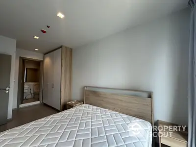 Modern bedroom with wooden furniture and large wardrobe in a stylish apartment.