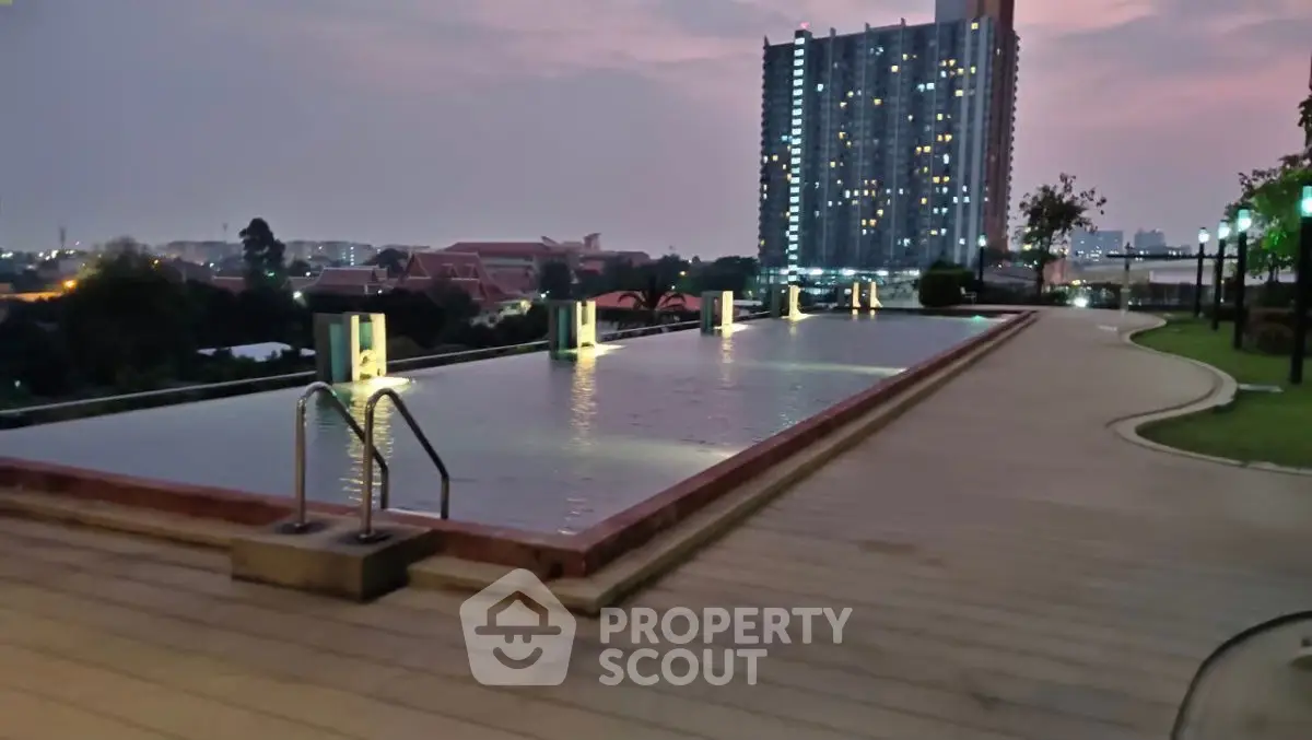 Luxurious rooftop pool with stunning cityscape views at dusk, perfect for relaxation and leisure.