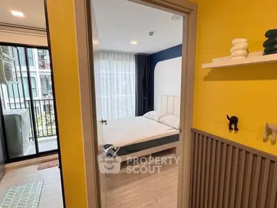 Modern bedroom with balcony access in stylish apartment, featuring bright yellow walls and contemporary decor.