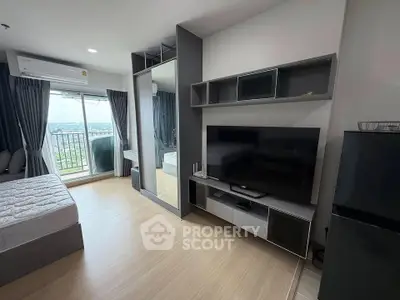 Modern bedroom with balcony view, featuring sleek furniture and ample natural light.