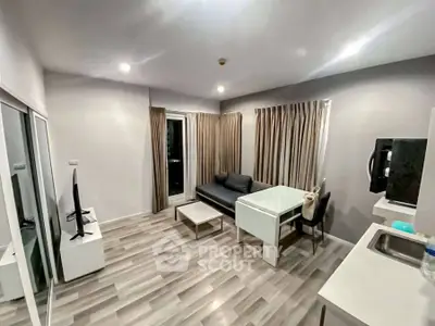Modern living room with sleek furniture and open kitchen layout, perfect for urban living.