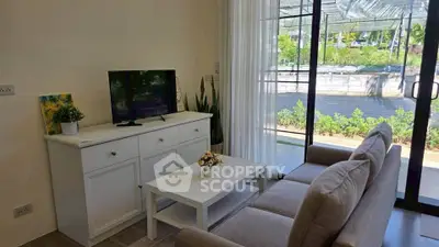 Charming living room with modern decor and garden view, perfect for relaxation and entertainment.