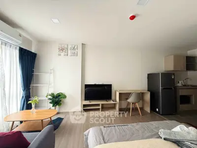 Modern studio apartment with open layout, featuring cozy living area, compact kitchen, and stylish decor.