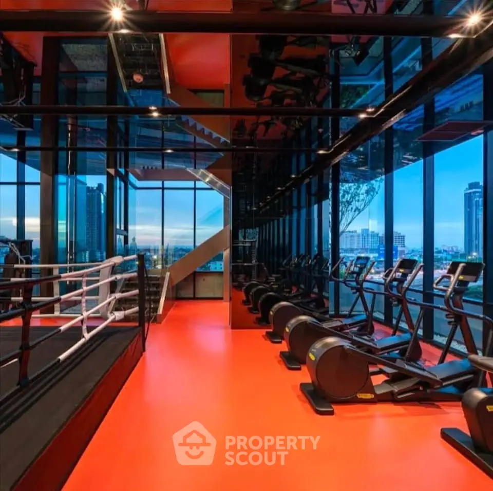 Luxurious high-rise gym with panoramic city views and modern fitness equipment.