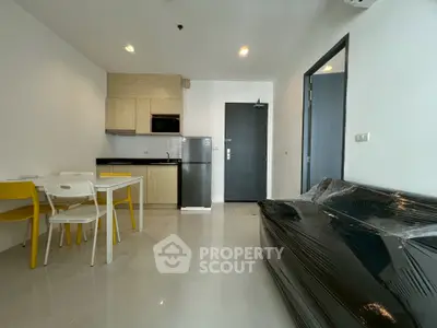 Modern apartment interior with compact kitchen and cozy living area