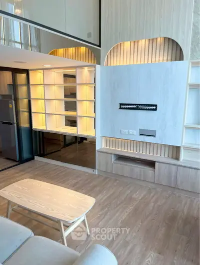 Modern living room with built-in shelves and sleek wooden flooring