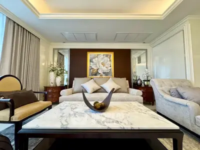 Luxurious living room with elegant decor and marble coffee table, perfect for sophisticated living.