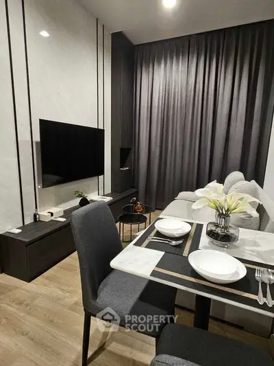 Modern living room with sleek furniture and elegant dining setup, perfect for urban living.