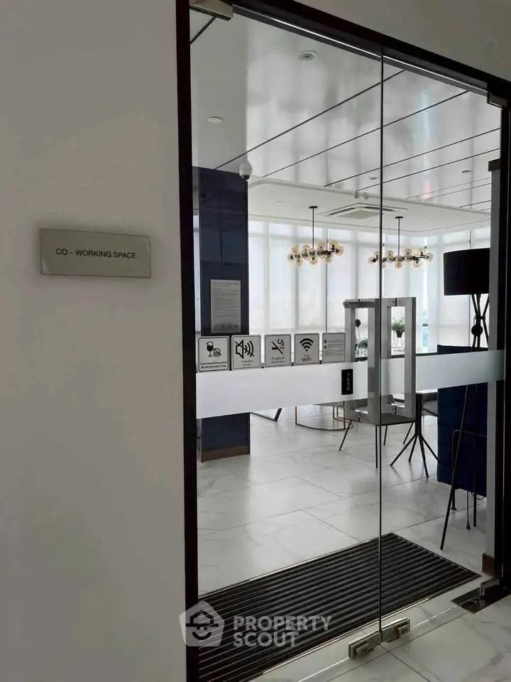 Modern co-working space with glass doors and sleek interior design