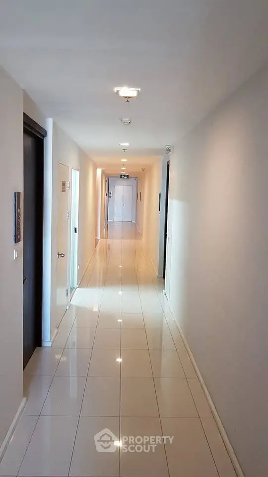 Sleek modern corridor with glossy tiled flooring in a contemporary building.