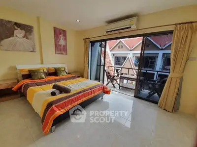 Cozy bedroom with balcony view and vibrant decor in modern apartment