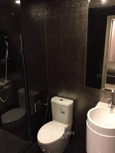 Modern bathroom with sleek black tiles and contemporary fixtures