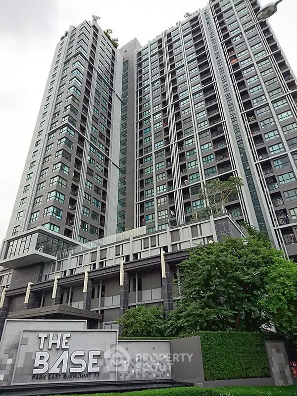 Modern high-rise condominium with lush greenery at The Base Park East Sukhumvit 77.