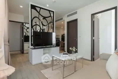 Modern living room with stylish decor and open layout, featuring a sleek TV stand and cozy seating area.