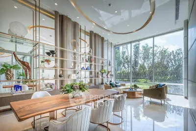 Luxurious modern living room with floor-to-ceiling windows and elegant decor overlooking a serene garden.