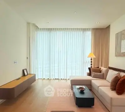 Elegant living room with modern decor and large windows offering natural light.