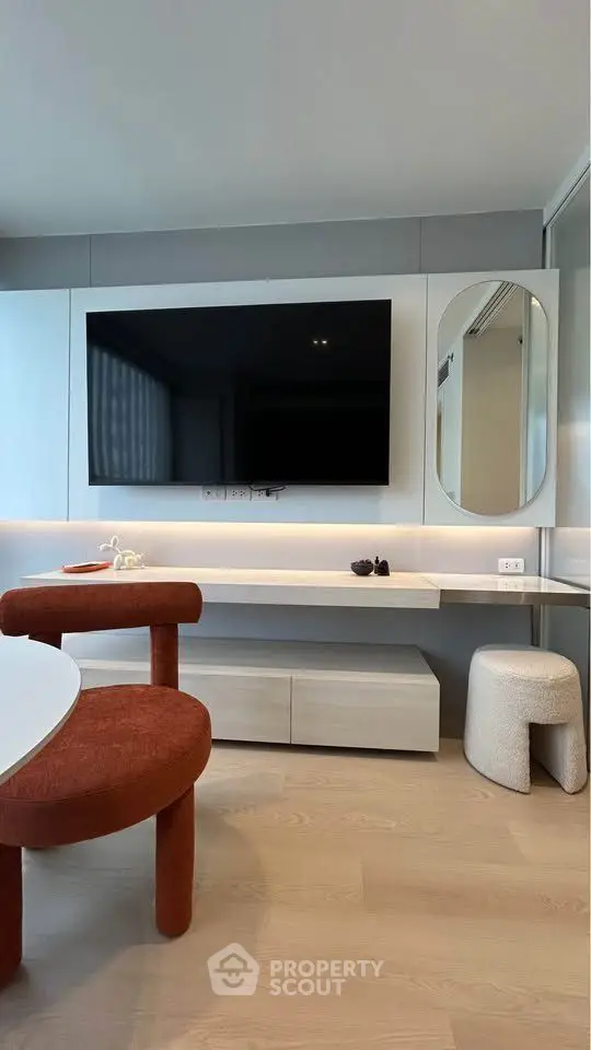 Modern living room with sleek TV setup and stylish furniture, perfect for contemporary urban living.