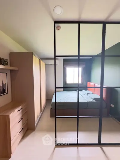 Modern bedroom with stylish glass partition and cozy bed