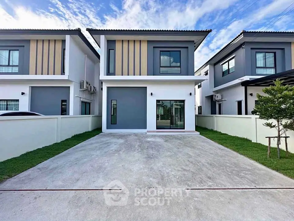 Modern two-story house with sleek design and spacious driveway in a serene neighborhood.
