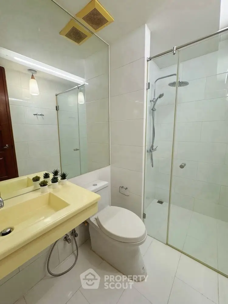 Modern bathroom with glass shower and sleek fixtures