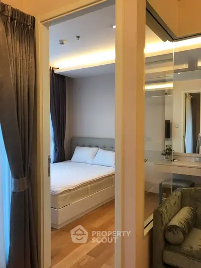 Cozy bedroom with elegant decor and wooden flooring in modern apartment