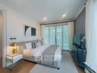 Luxurious bedroom with elegant decor and large windows for natural light.