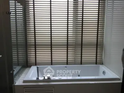 Luxurious bathroom with modern bathtub and stylish blinds