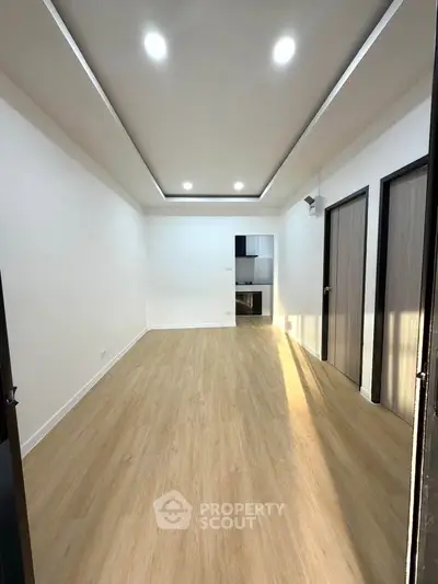 Spacious modern living room with wooden flooring and recessed lighting