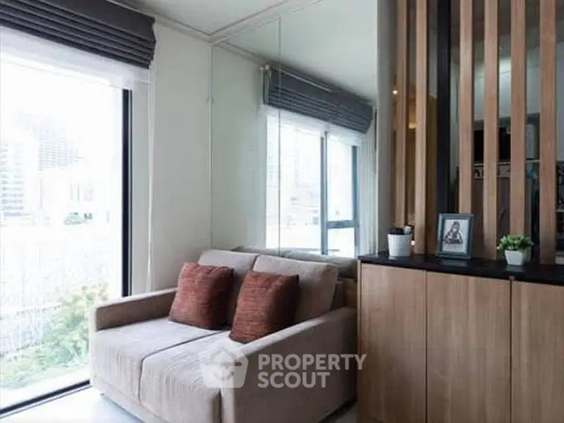 Modern living room with cozy sofa and large windows for natural light