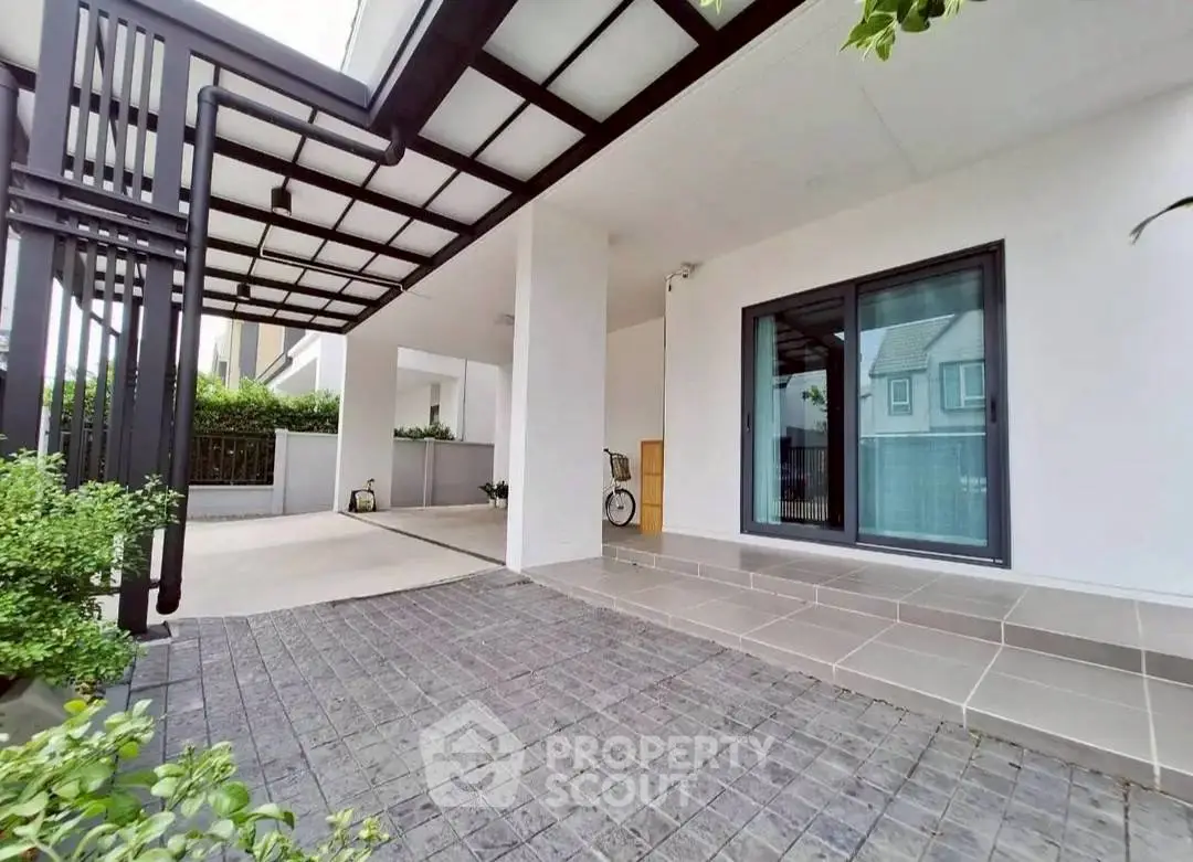 Modern house exterior with covered patio and large sliding glass door