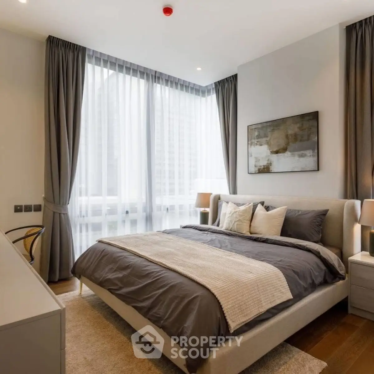 Luxurious modern bedroom with large windows and elegant decor in a high-rise apartment.