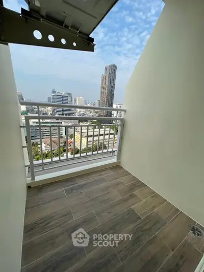 Charming city view from a cozy balcony with modern flooring, perfect for relaxation.
