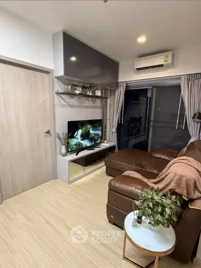 Modern living room with brown leather sofa and wall-mounted TV