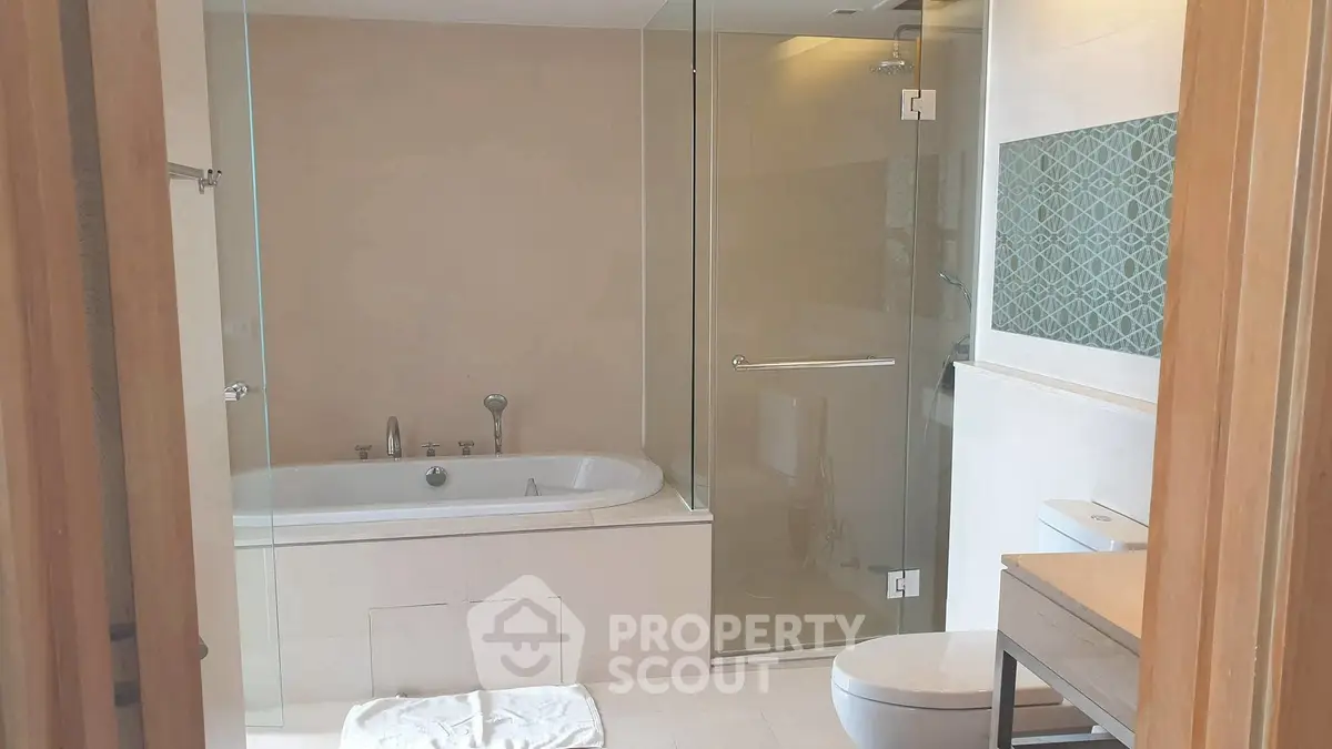 Modern bathroom with bathtub and glass shower enclosure