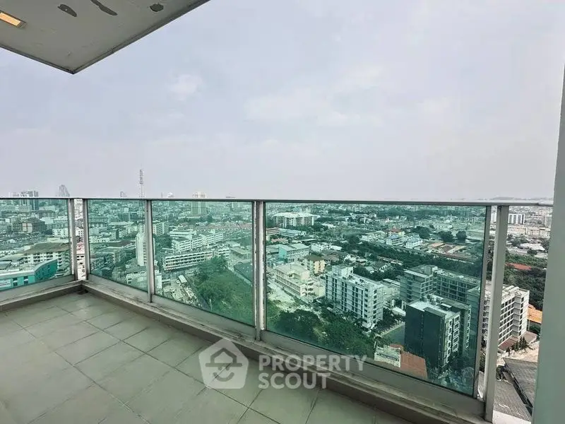 Stunning cityscape view from a spacious high-rise balcony, perfect for urban living.