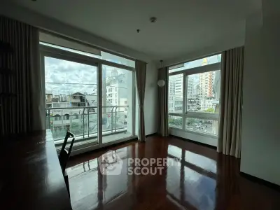 Spacious corner unit with large windows offering a stunning city view, perfect for a modern living room setup.