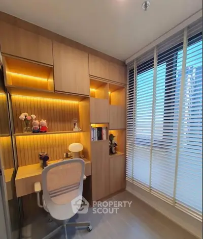 Modern study room with built-in wooden shelves and large window with blinds