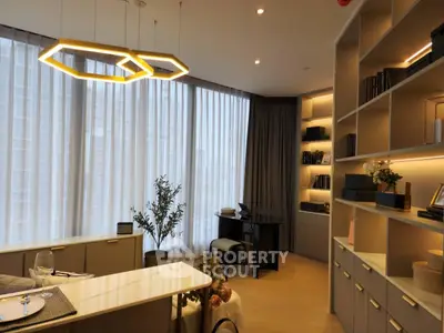 Modern living room with elegant lighting and floor-to-ceiling windows