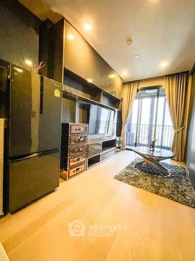 Modern living room with sleek black fridge and balcony view
