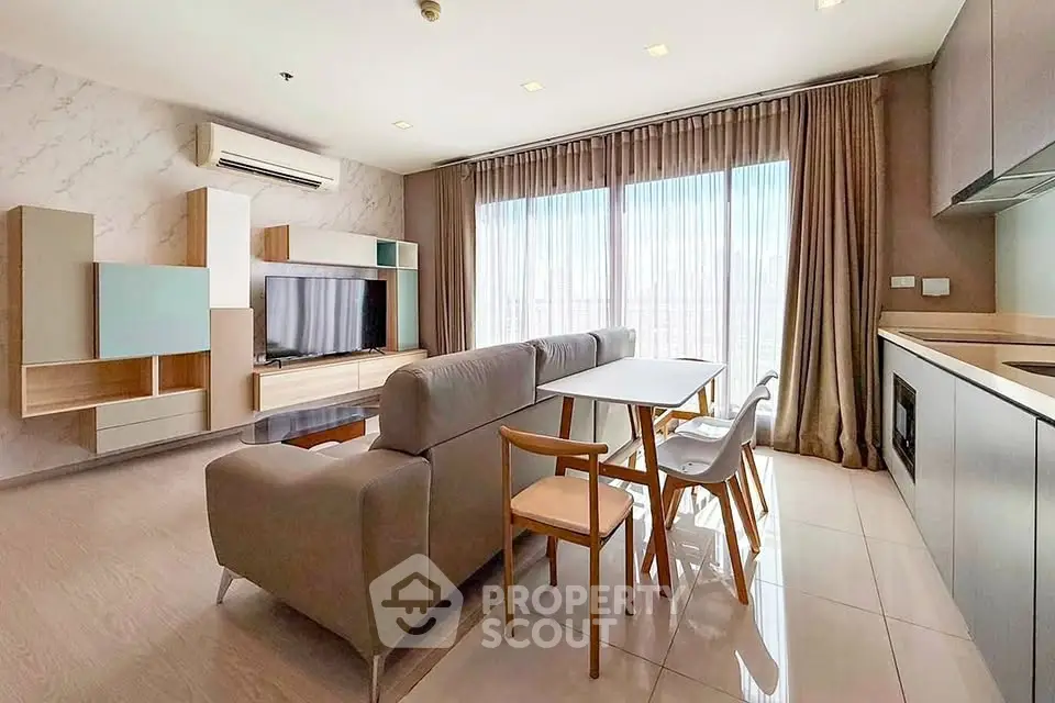 Modern living room with stylish furniture and large windows in a contemporary apartment.