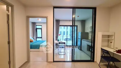 Modern apartment interior with open kitchen and cozy bedroom view
