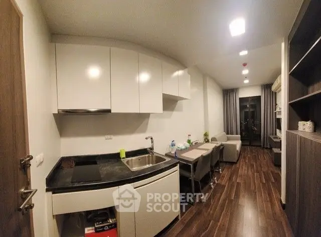 Modern kitchen with sleek cabinets and open layout in cozy apartment