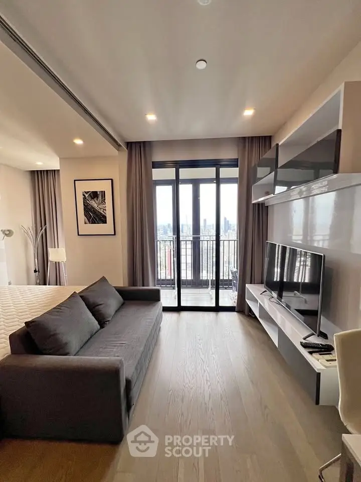 Modern living room with sleek furniture and city view balcony in luxury apartment.