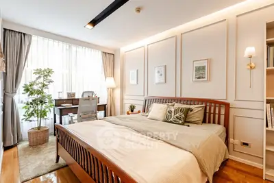 Elegant bedroom with wooden bed, cozy decor, and natural light from large window.