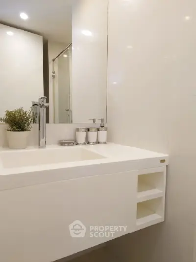 Modern bathroom with sleek white sink and elegant fixtures