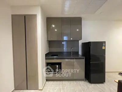 Modern compact kitchen with sleek cabinets and appliances