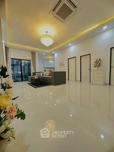 Spacious modern living room with elegant chandelier and sleek design